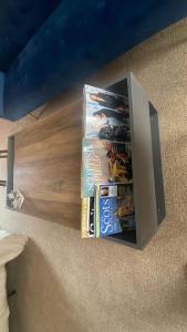 a box of dvds and snacks on the floor at large room with garden area with direct access onto beach in Fife