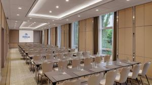 a row of tables and chairs in a room at Hilton Munich City in Munich