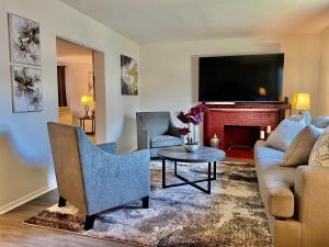 a living room with a couch and a tv at Glendora Pool Home Retreat in Glendora