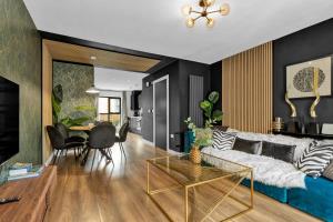 a living room with a blue couch and a table at Free Parking Luxury Safari House in Manchester
