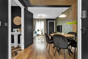 a dining room with a table and black walls at Free Parking Luxury Safari House in Manchester