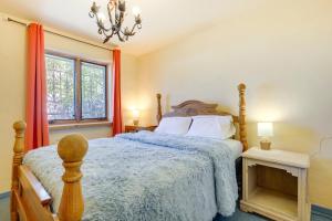 a bedroom with a bed and a window and a chandelier at Beautiful Española Retreat with Patio! in Espanola