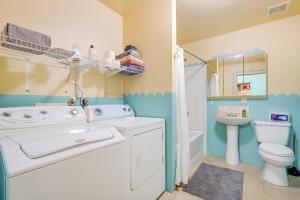 a bathroom with a washing machine and a toilet at Beautiful Española Retreat with Patio! in Espanola