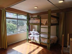 a bedroom with two bunk beds and a window at Tin House Quito in Quito