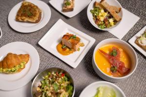 a bunch of plates of food on a table at Conrad New York Downtown in New York