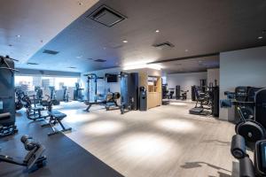 un gimnasio con cintas de correr y máquinas en una habitación en Hilton Nagoya Hotel, en Nagoya