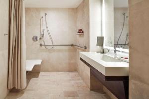 a bathroom with a sink and a shower at Conrad New York Downtown in New York
