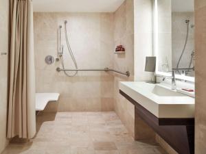 a bathroom with a sink and a shower at Conrad New York Downtown in New York