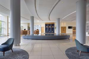 a lobby with two chairs and a waiting room at Hilton Newcastle Gateshead in Newcastle upon Tyne