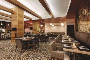 a restaurant with tables and chairs and a dining room at Hilton Garden Inn New York Manhattan Midtown East in New York