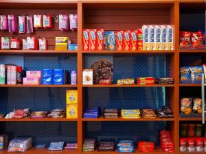 a shelf filled with lots of different types of food at AMTD Idea Tribeca Hotel in New York