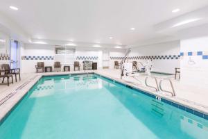 a swimming pool with blue water in a building at Hilton Garden Inn Oakland/San Leandro in San Leandro