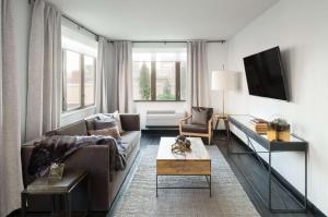 a living room with a couch and a tv at AMTD Idea Tribeca Hotel in New York