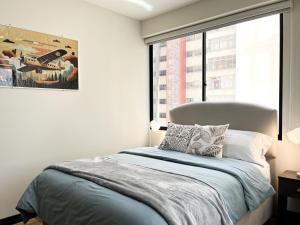 a bedroom with a bed and a large window at Sky Suites - Incredible 2 Bedroom Apartment in La Paz in La Paz