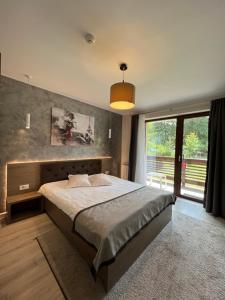 Postel nebo postele na pokoji v ubytování Garden Apart Predeal + 37 fotografií