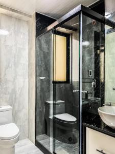 a bathroom with a shower and a toilet and a sink at Sky Suites - Incredible 2 Bedroom Apartment in La Paz in La Paz