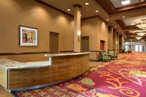 a lobby with a reception desk in a hotel at Embassy Suites Omaha- La Vista/ Hotel & Conference Center in La Vista
