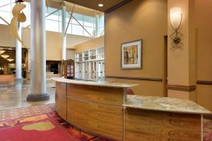 a lobby with a reception desk in a building at Embassy Suites Omaha- La Vista/ Hotel & Conference Center in La Vista
