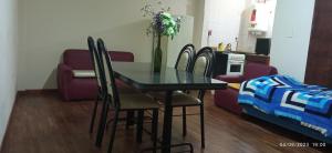 a dining room with a table and chairs and a couch at Morita INN in San Salvador de Jujuy +4 photos