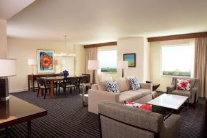 a living room with a couch and a dining room at Hilton Orlando in Orlando