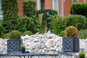 a garden with a pile of rocks and a fountain at Hilton Northampton Hotel in Northampton