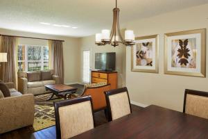 a living room with a table and a dining room at Hilton Grand Vacations Club SeaWorld Orlando in Orlando