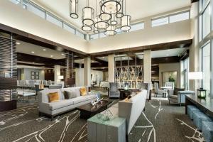 a large lobby with couches and tables and a chandelier at Hilton Garden Inn Palo Alto in Palo Alto