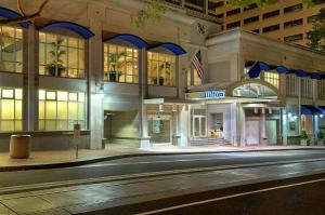 a hilton building on a city street at night at Hilton Portland Downtown in Portland