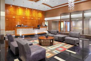 a lobby with a waiting area with chairs and a table at DoubleTree by Hilton Palm Beach Gardens in Palm Beach Gardens
