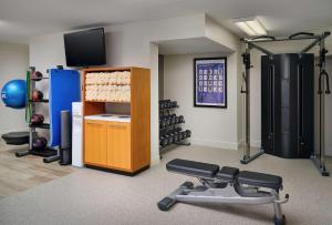 a fitness room with a gym with weights at DoubleTree by Hilton Palm Beach Gardens in Palm Beach Gardens
