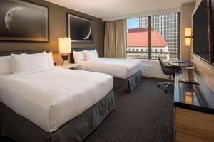 a hotel room with two beds and a large window at Hilton Portland Downtown in Portland