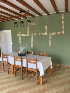 a dining room with a white table and chairs at Domaine des deux sapins in Voillecomte