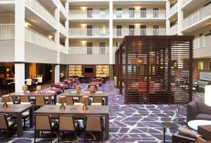 a rendering of a restaurant with tables and chairs at Embassy Suites by Hilton Philadelphia Airport in Philadelphia