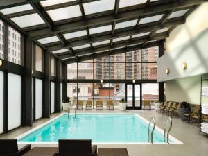 a large pool in a building with windows at DoubleTree by Hilton Hotel Philadelphia Center City in Philadelphia
