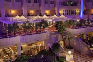 a building with a restaurant in the middle of it at night at Hilton Prague Hotel in Prague