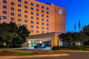 a hotel with a car parked outside of it at Embassy Suites by Hilton Raleigh Durham Research Triangle in Cary
