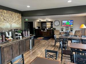 a restaurant with tables and chairs and a clock on the wall at Super 8 by Wyndham Durango in Durango