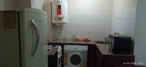 a kitchen with a refrigerator and a washing machine at Morita INN in San Salvador de Jujuy