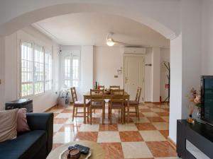 a living room with a dining room table and chairs at Terraced Home in Cabo Roig in Cabo Roig