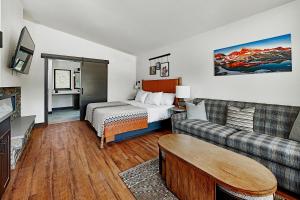 マンモス・レイクスにあるOutbound Mammothのベッドとソファ付きのホテルルーム