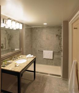 a bathroom with a sink and a shower at The Strathallan - a DoubleTree by Hilton in Rochester