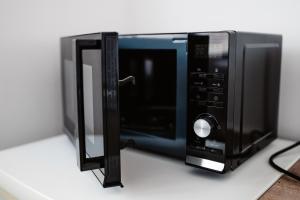 a black microwave oven sitting on a counter at Apartmán Nová Nemocnica 10min. pešo do Centra in Košice +23 photos