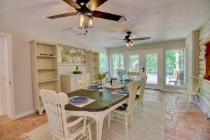 a kitchen and dining room with a table and chairs at Unplug and Recharge: Bayou Log Cabin Retreat in Dickinson