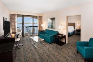 a hotel room with a bed and a living room at Hilton San Diego Airport/Harbor Island in San Diego