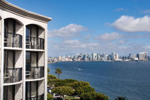 a building with a view of the ocean and a city at Hilton San Diego Airport/Harbor Island in San Diego