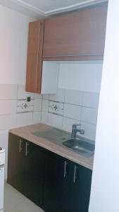 a kitchen with a sink and a counter top at Jp Appartement in Lomé