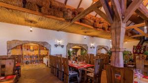 a dining room with tables and chairs in a restaurant at Hilton Sibiu in Sibiu