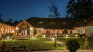 a large building with a yard at night at Hilton Sibiu in Sibiu