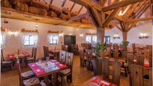 a restaurant with wooden tables and chairs in a room at Hilton Sibiu in Sibiu +55 photos