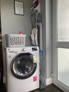 a washer and dryer in a laundry room at The Stay @ 155 